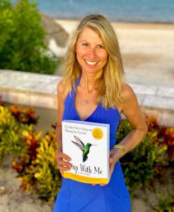 Author Laurie Smith holding her book Leap With Me: A Creative Path to Finding and Following Your True Voice