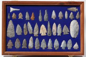 Collection of around 90 Paleo points (arrowheads) that included a wide variety of shapes and materials, high-grade flints of mostly lanceolate structure, in three display cases ($8,750).