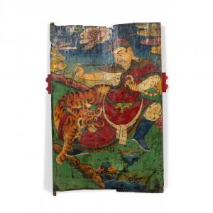 Tibetan polychrome painted wood door depicting a guardian spirit with a tiger on a chain in a celestial landscape, 58 ½ inches by 40 inches, attached to a red painted wood frame ($17,500).