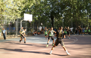 Two Pinoy basketball teams play on the court with a referee watching every move.