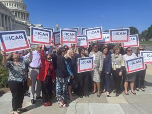 Group of nursing association leadership and APRNs with I CAN signs in front of Capitol