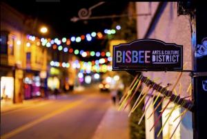 Bisbee Arizona arts and culture district sign with downtown lights in the background