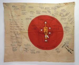 Cotton World War II Japanese flag with Rising Sun, 41 inches by 49 inches, with 2nd Marine Division insignia painted on red center, signed by 45 marines (est. $200-$400).