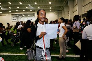 HBCU Week College Fair participant smiles upon receiving her college acceptance & scholarship