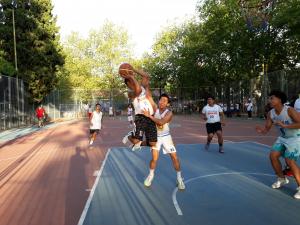 Two players try to grab the ball while almost midair