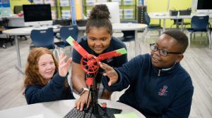 Three students working on a propeller project