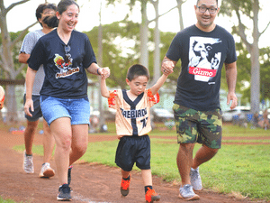 NQD family hold child's hand walking