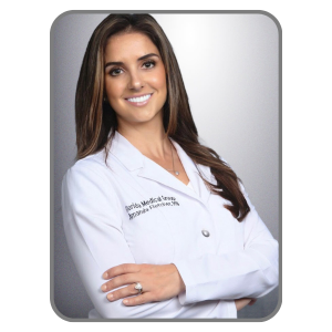 young Caucasian female nurse wearing lab coat standing with arms folded smiling professional headshot