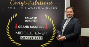 Johnny Kollin holding his SolarQuarter Grand Masters Middle East Awards 2022 trophy.