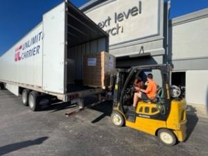 Unloading needed essential supplies from an Unlimited Carrier truck at a local Florida drive through relief location.