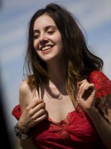 Alison Brie as Ella enjoys her new red dress