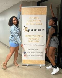 Culver-Stockton College Students pose with the Royal Horizon Banner indicating the future home of the healthy and beauty vending machine.