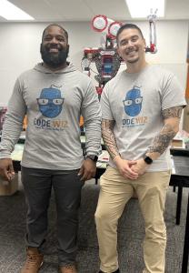 Picture featuring Tierrasanta Code Wiz owners and Navy veterans Davon Copeland, left, with the Code Wiz Robot in the center, and Richard Daos right.