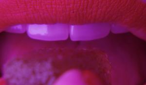 Woman Eating a Delicious Tart Cherry C60 Gummy
