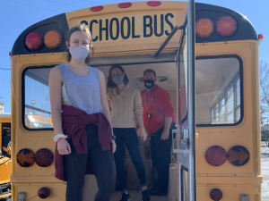 Staff of Community Action Lexington stand at the back of a bus