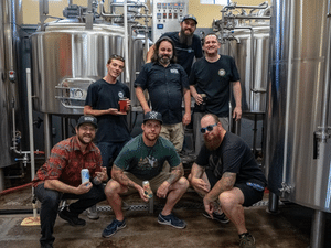 12 West team group photo in brewing room