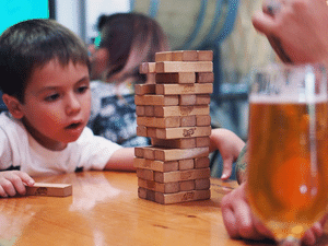 young boy playing jenga at 12 West