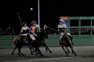 arena polo player hits ball into the air at Twilight Polo USPA US Open Arena Polo Championship