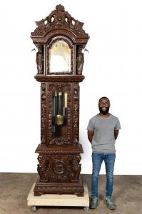 Carved walnut tall case (or grandfather) clock, made in the last quarter of the 20th century in the Renaissance Revival manner of R. J. Horner, with an earlier Tiffany movement (est. $6,000-$8,000).