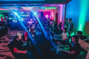 Gamers play and compete in decorated esports arenas with equipment provided by Unified.