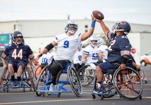 A Dallas Cowboys Wheelchair Football Player goes against a Chicago Bears Wheelchair Football Player during a USA Wheelchair Football League Tournament.