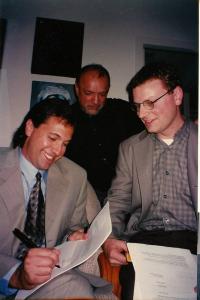 Steve Alten and Ken Atchity and One Other Hold Pen and Paper As They Sign The Contract For 'The Meg"