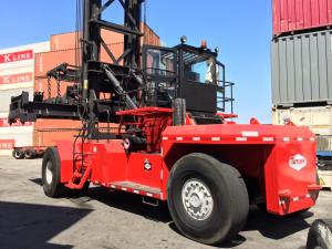 A Taylor Machine Works TEC950 Lift Truck in a port setting with containers in the background.