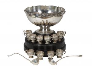 Early 20th century 15-piece sterling silver punch set by Whiting, consisting of a large punchbowl, in a grape and vine motif, 12 matching punch cups, and two punch ladles (est. $4,000-$8,000).