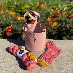 pink leather bag with breast cancer ribbon handles with pink yarn and pattern