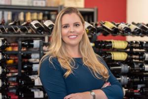 Alessandra Esteves, pictured in front of bottles