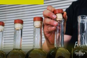 Detail of caps and glass bottles in a tequila distillery affected by the input shortages