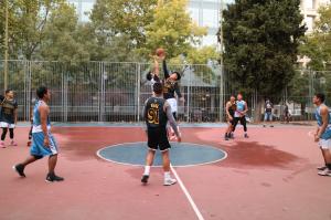Filipino basketball players trying to grab a ball at the beginning of the game