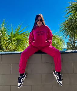 Women in pink hoodie and jogger.