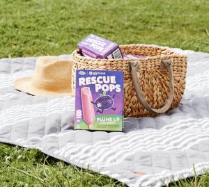 Box of Rescue Pops on a picnic rug outside