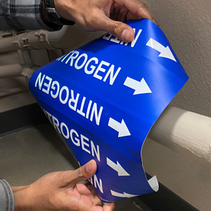 Flowfinder Snap Pipe Marker shown being applied with arrows indicating pipe content flow.