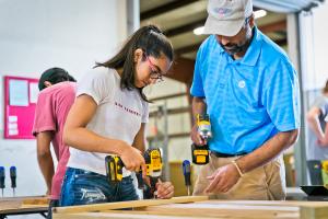 2 volunteers building a headboard for our beds before we deliver them to kids in need within our own community