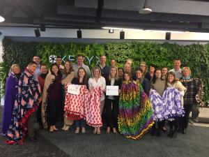 Keryx employees with blankets they made for dialysis patients