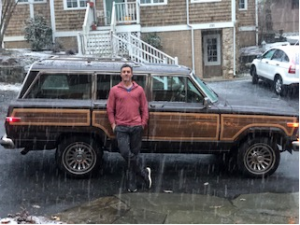 Michael McDevitt in front of a car in the snow