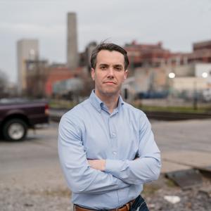 Candidate Morgan McGarvey poses in an urban setting in Louisville, Ky.