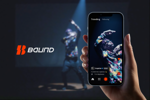 Video still of a man performing a dance routine on a dark stage with a spotlight on him