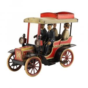 Georges Carette & Co. #50 lithographed tin toy car (French, 1910s), with original painted driver and passengers, removable headlamps and luggage rack (est. CA$2,500-$3,500).