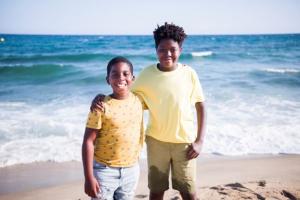 Two African boys are looking happy and well on the beach