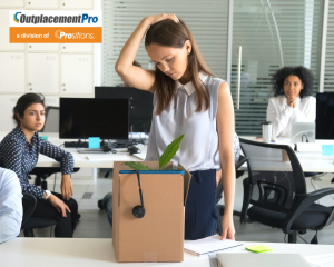 Image includes the OutplacementPro Logo with "a division of Prositions" written below in an orange box. The image also includes an individual packing up her work station in an open-office area.