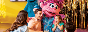 Sesame Place - Zoe interacting with family at a table
