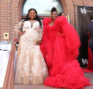 Former plus-size model Meesha Ann (champagne dress) poses with plus-size stylist Sharonda Grandberry (red dress) outside The Full Figured Industry Awards.