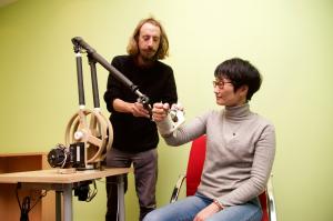 Professor Ying Tan working with Dr Vincent Crocher on the prototype of the EMU 3D upper limb robotic rehabilitation equipment