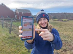 Morning Ag Clips President Kate Ziehm with Morning Ag Clips Mobile on her phone.