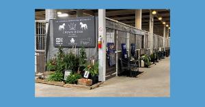 An image of Crown Ridge Farms' competition-winning tack area display, including the black and white foam sign and small Christmas trees.