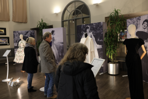 Patrons strolling and examining the dresses displayed at the Paris Night Looks exhibition during 1st Thursday Santa Barbara Artwalk