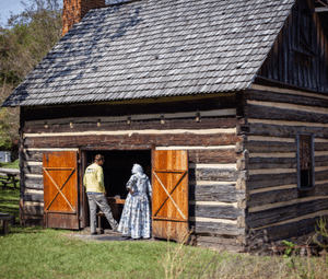 HP Museum outdoor exhibit of barn with two settlers walking in